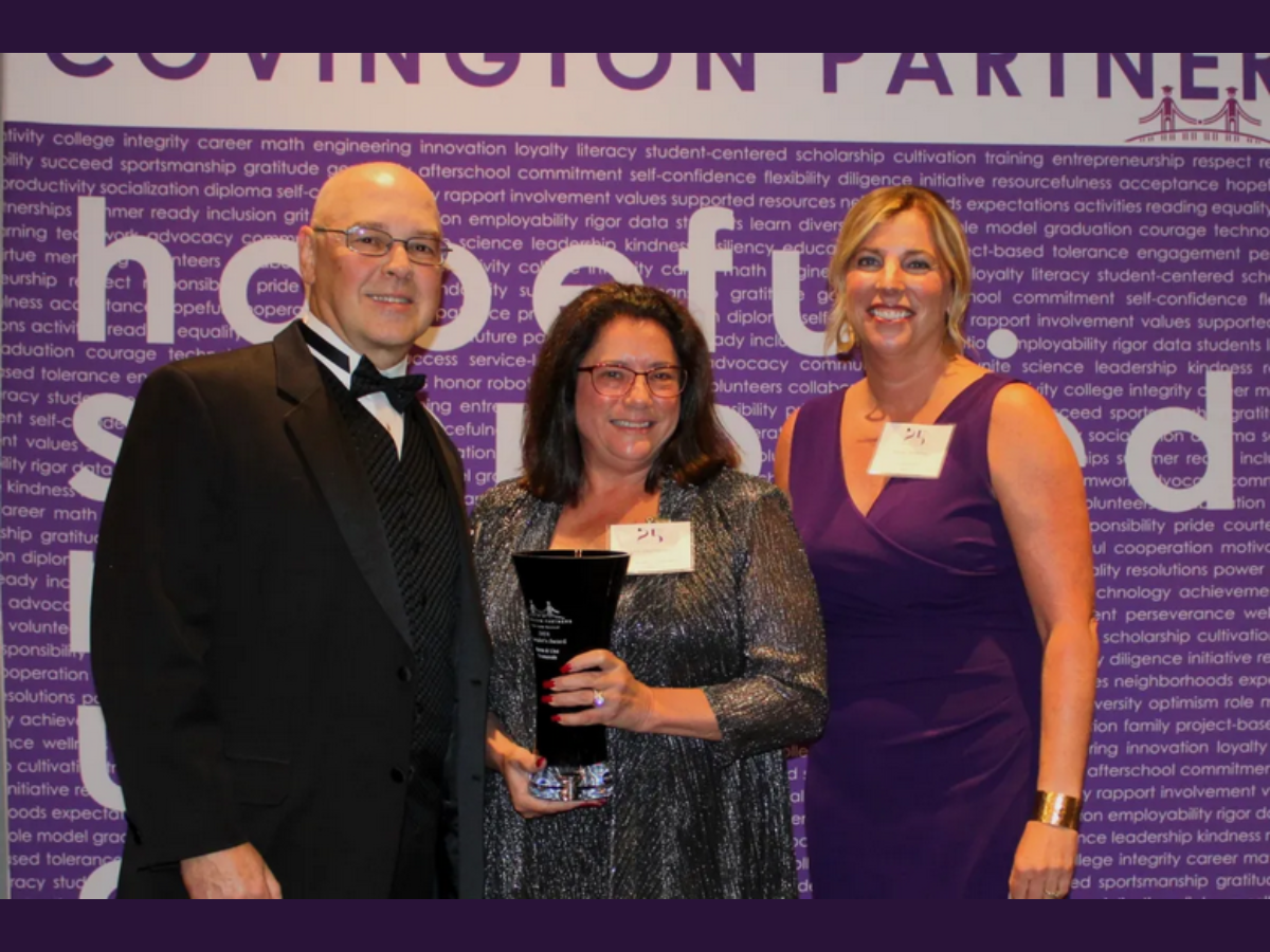 Stacie Strotman and Lisa Desmarais standing with award