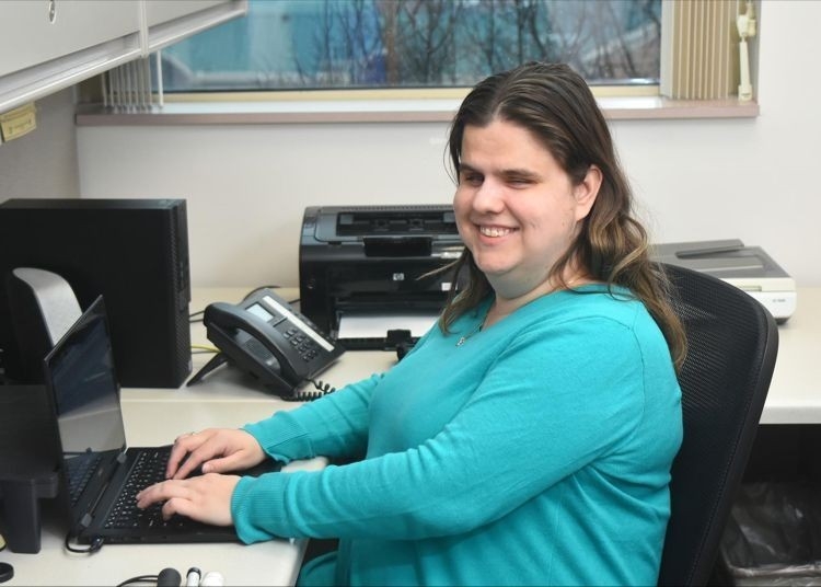 Jennifer Holladay sitting at her office desk