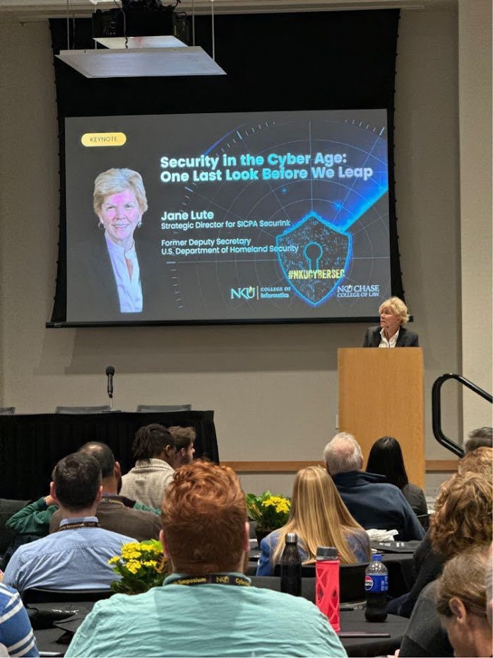 Jane Lute speaking during her session over lunch in the ballroom