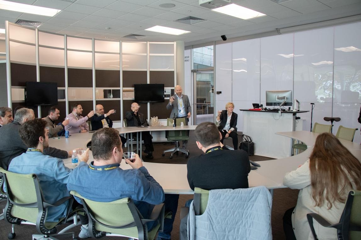 Cyber16 attendees in a room socializing with cocktails