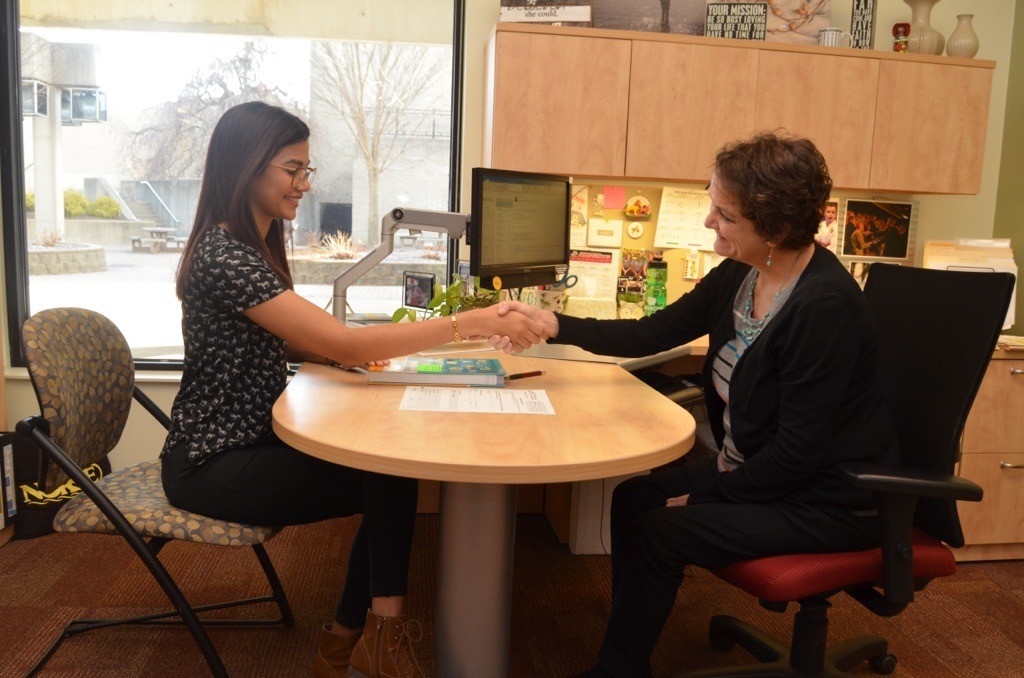 Peg Adams, UCAP director, meeting with a student